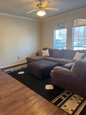 a living room with a bed furniture and a window