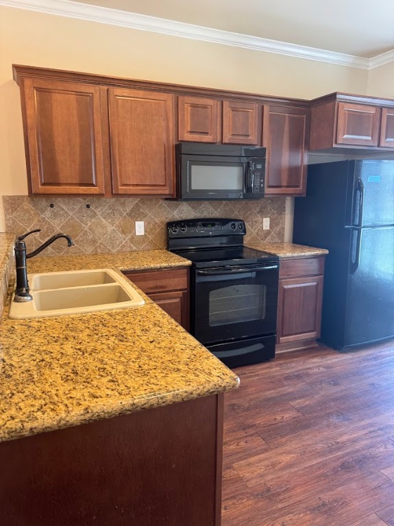 1198 Jones-Butler Road, Unit 1904 College Station, TX 77840 - Photo 4 of 17 a kitchen with wooden cabinets and a stove top oven