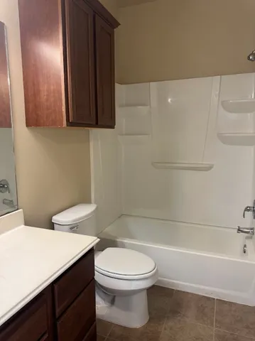 a bathroom with a toilet a sink and bathtub