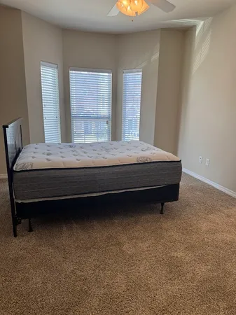 a bedroom with bed and window