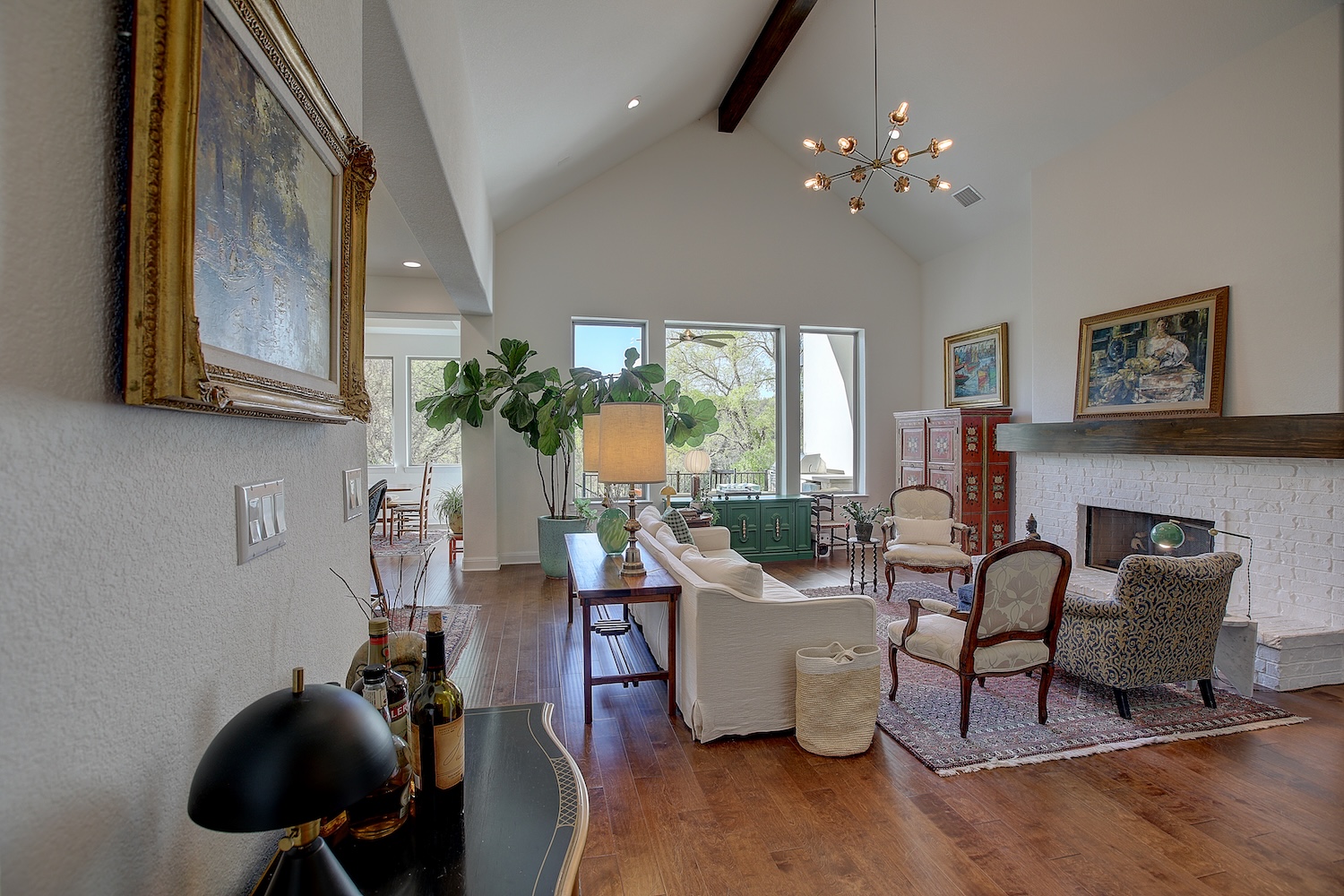 129 Hollytree Court Georgetown, TX 78628 - Photo 17 of 40 Magnificent family room features a lovely gas fireplace with custom mantle, soaring vaulted ceilings with wood beam, and open concept gathering space.