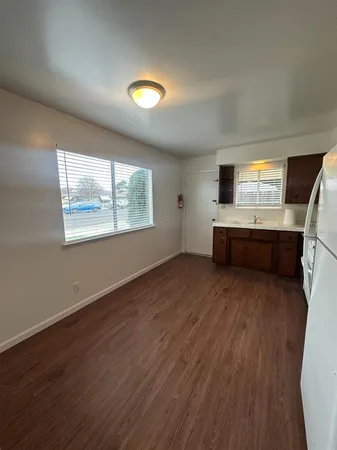 a view of room with wooden floor and windows