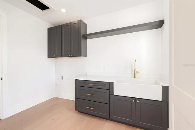 a spacious bathroom with a double vanity sink mirror and bathtub