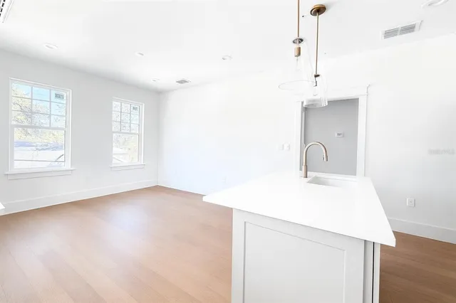 a view of a bedroom with a bed and a dresser
