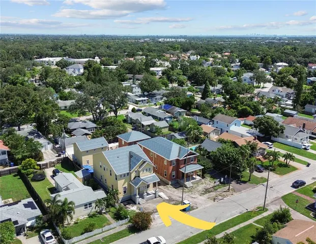 an aerial view of residential houses with outdoor space