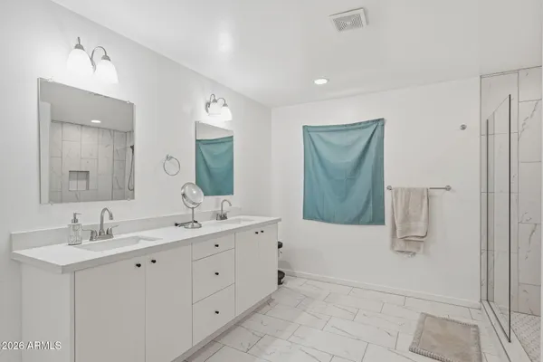 a bedroom with a bed and a chair