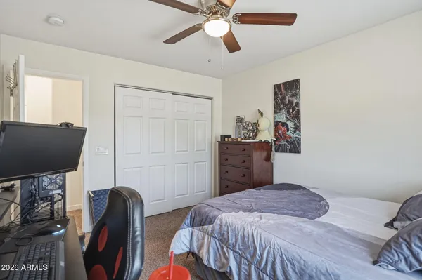 a work room with furniture and a ceiling fan