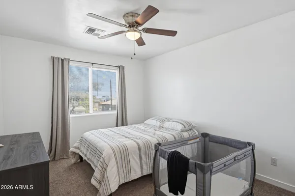 a living room with furniture a rug and a book shelf
