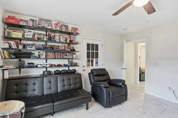 a view of a house with large windows and a tree