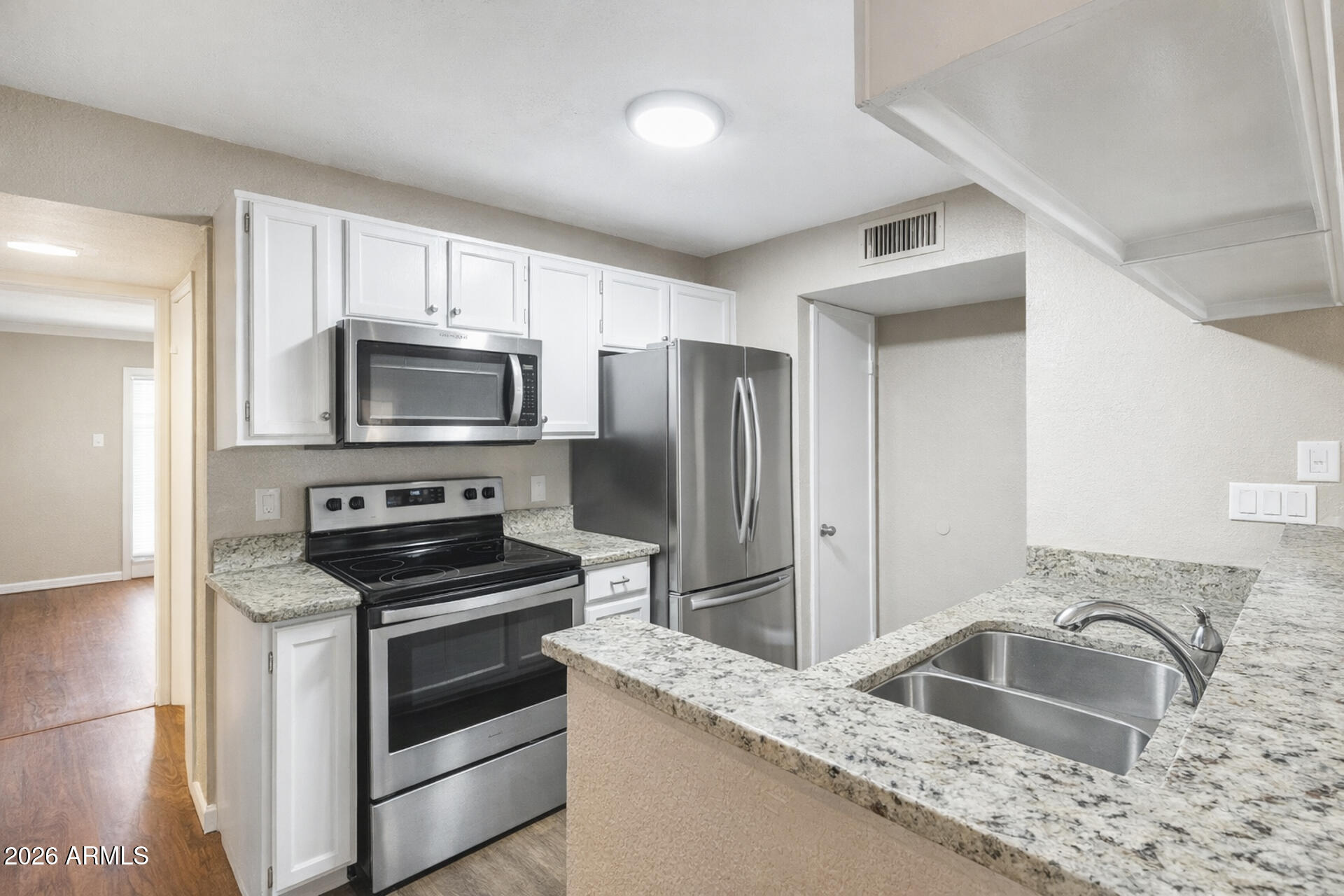 30 East Brown Road, Unit 2040 Mesa, AZ 85201 - Photo 11 of 23 a kitchen with granite countertop a sink stove and refrigerator
