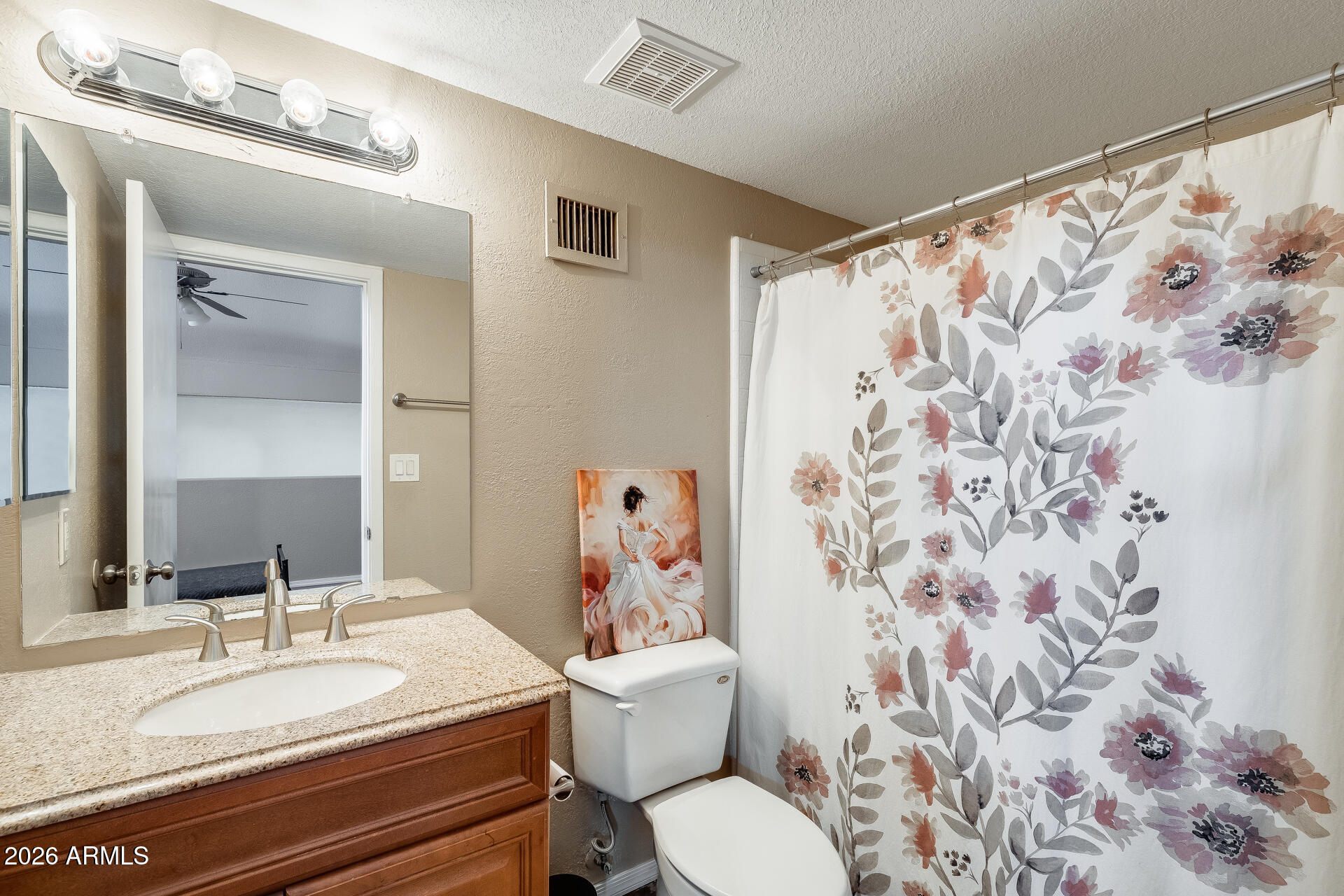 30 East Brown Road, Unit 2040 Mesa, AZ 85201 - Photo 19 of 23 a bathroom with a granite countertop toilet a sink and a mirror