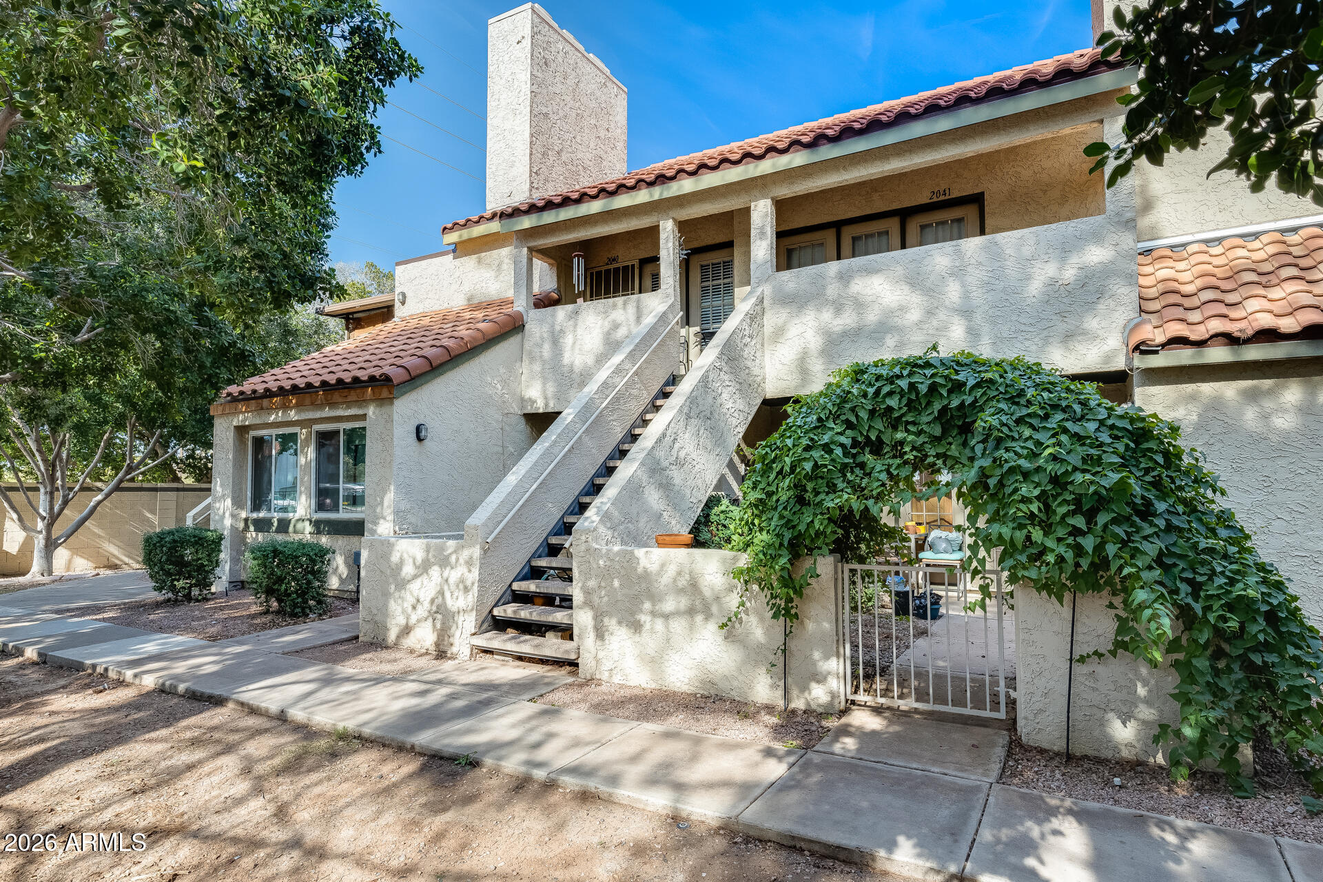 30 East Brown Road, Unit 2040 Mesa, AZ 85201 - Photo 6 of 23 a view of a house with a small yard and large tree