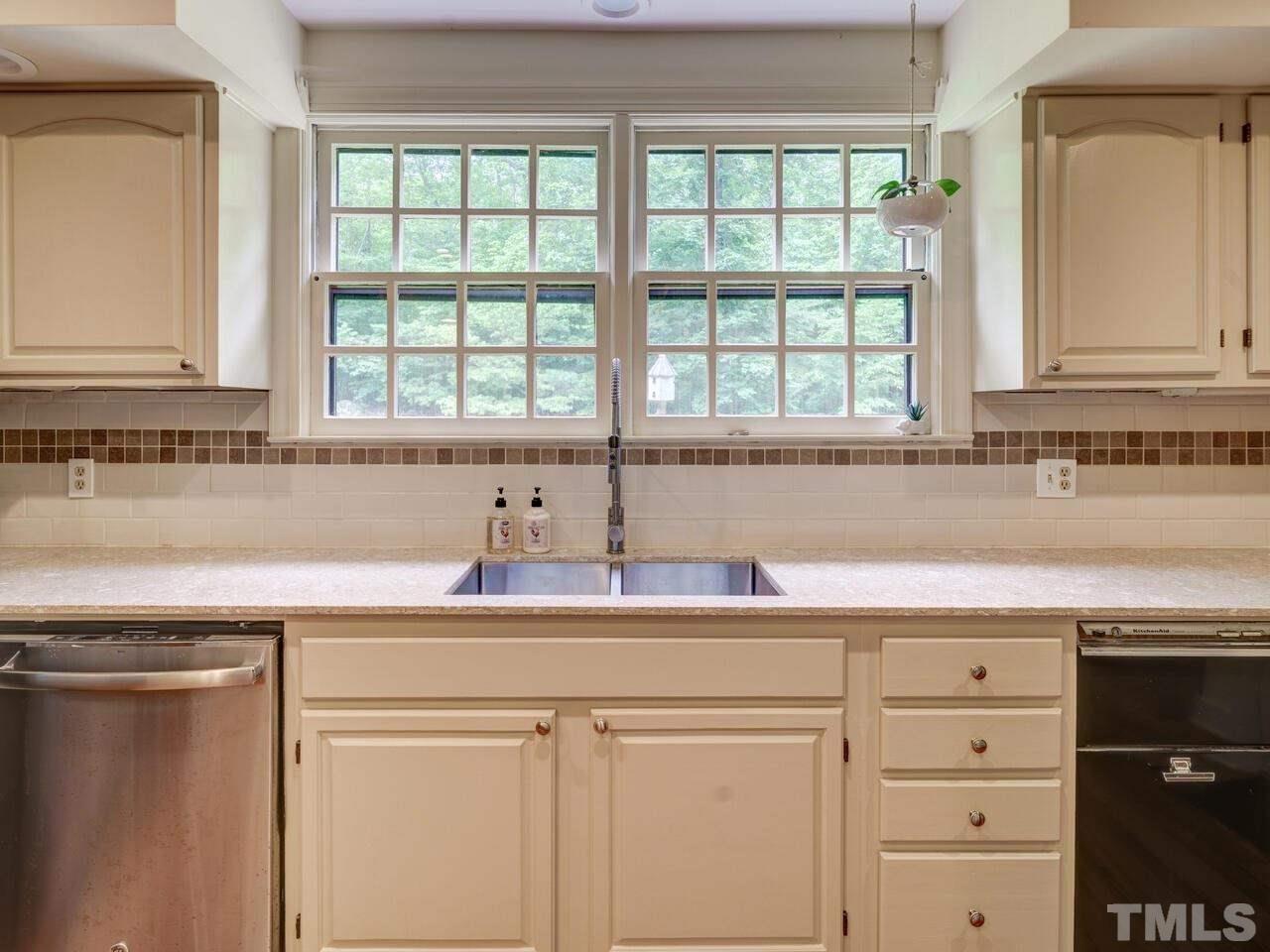 1100 Trail End Road Durham, NC 27712 - Photo 8 of 30 a kitchen with a sink cabinets and a window