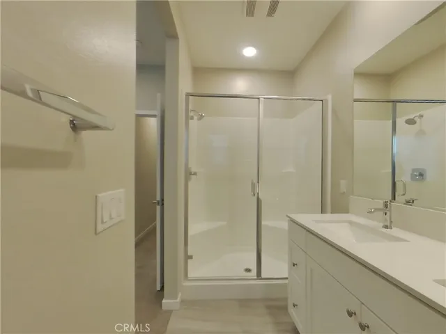 a bathroom with a shower sink and mirror