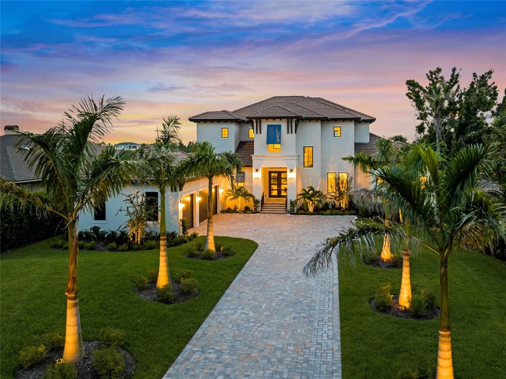 1109 Bayshore Road Nokomis, FL 34275 - Photo 1 of 63 a front view of a house with garden