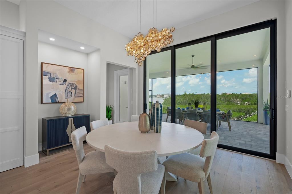 1109 Bayshore Road Nokomis, FL 34275 - Photo 14 of 63 a view of a dining room with furniture window and wooden floor