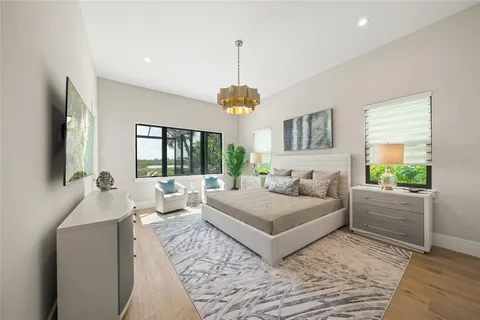 a bathroom with a granite countertop sink a mirror a bathtub and shower