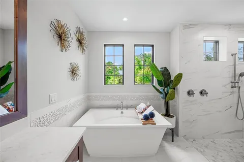 a bed room with a bed mirror and a window