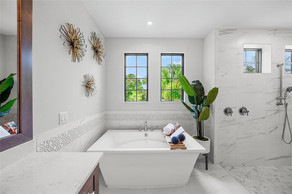 1109 Bayshore Road Nokomis, FL 34275 - Photo 19 of 63 a bath tub sitting in a bathroom next to a window