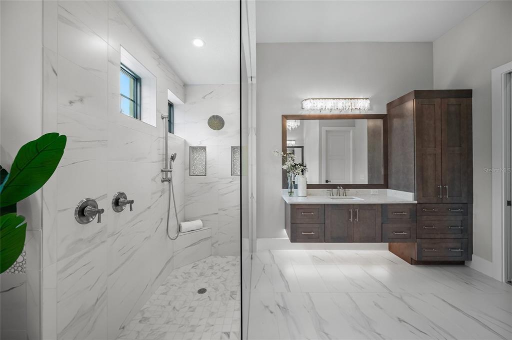1109 Bayshore Road Nokomis, FL 34275 - Photo 20 of 63 a bathroom with a granite countertop sink a mirror a bathtub and shower
