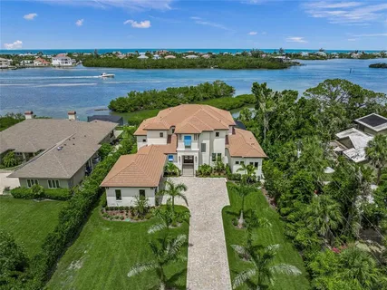 an aerial view of a house with a garden and lake view