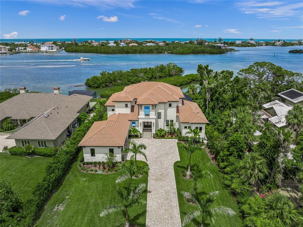 1109 Bayshore Road Nokomis, FL 34275 - Photo 2 of 63 an aerial view of a house with a garden and lake view