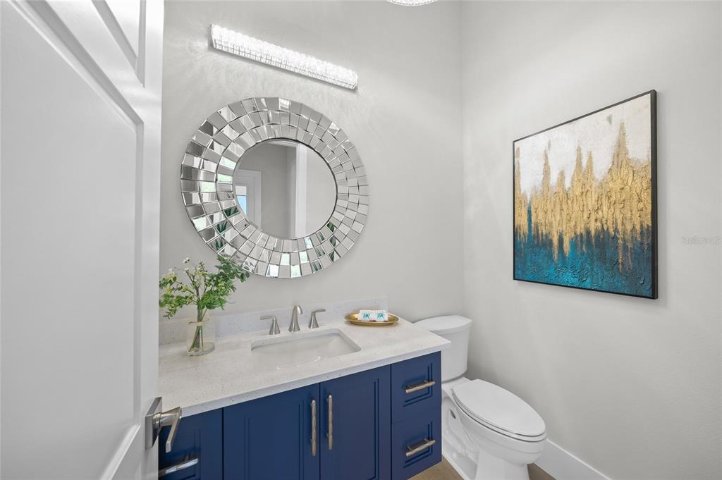 1109 Bayshore Road Nokomis, FL 34275 - Photo 23 of 63 a bathroom with a toilet sink and mirror