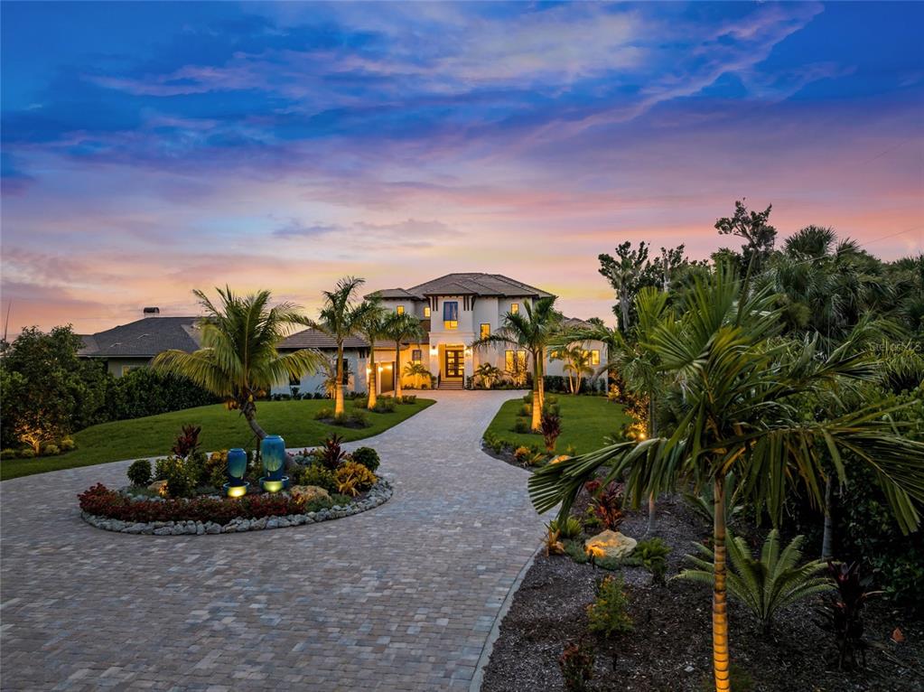 1109 Bayshore Road Nokomis, FL 34275 - Photo 3 of 63 a view of a street with a car park fire pit and couches in the patio