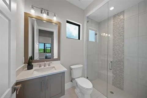 a living room with patio furniture and a floor to ceiling window