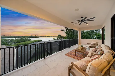 a view of balcony with wooden floor and a bench