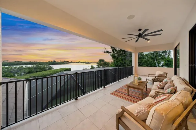 a view of balcony with wooden floor and a bench