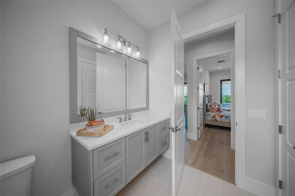 1109 Bayshore Road Nokomis, FL 34275 - Photo 40 of 63 a bathroom with a double vanity sink and mirror