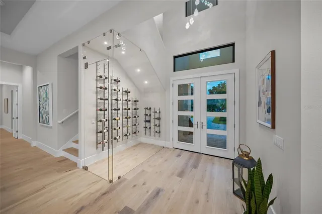 a view of a hallway with wooden floor and entryway