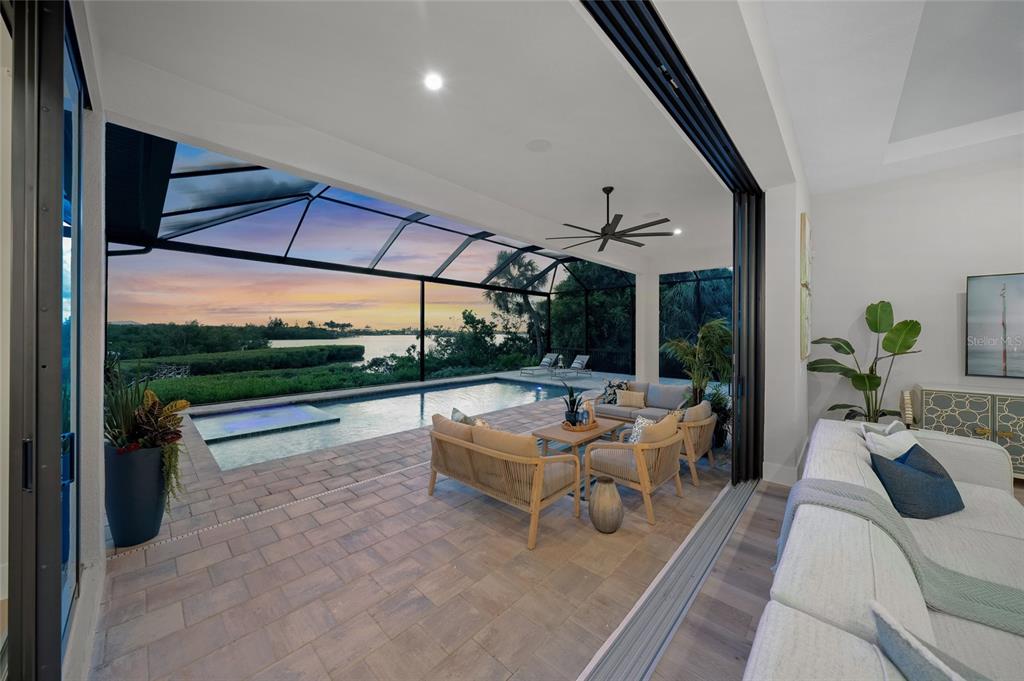 1109 Bayshore Road Nokomis, FL 34275 - Photo 41 of 63 a living room with patio furniture and a floor to ceiling window