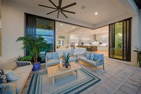 a front view of a house with a yard and palm trees