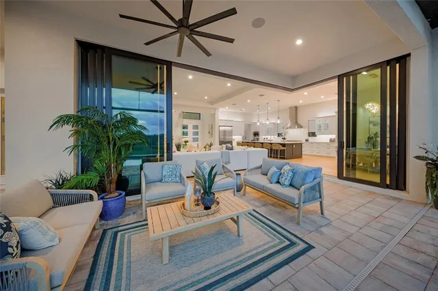 a front view of a house with a yard and palm trees
