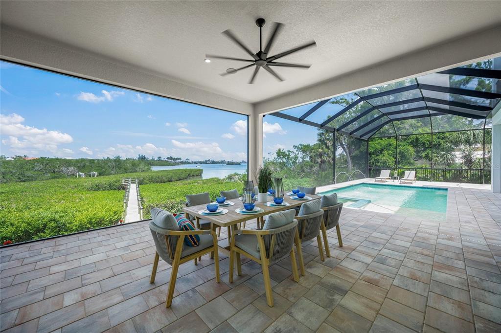 1109 Bayshore Road Nokomis, FL 34275 - Photo 44 of 63 a view of a patio with a table chairs and a patio