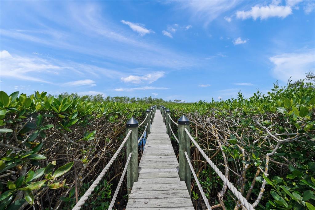 1109 Bayshore Road Nokomis, FL 34275 - Photo 50 of 63 a view of balcony with wooden floor and a bench
