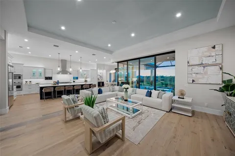 a living room with furniture floor to ceiling window and potted plant