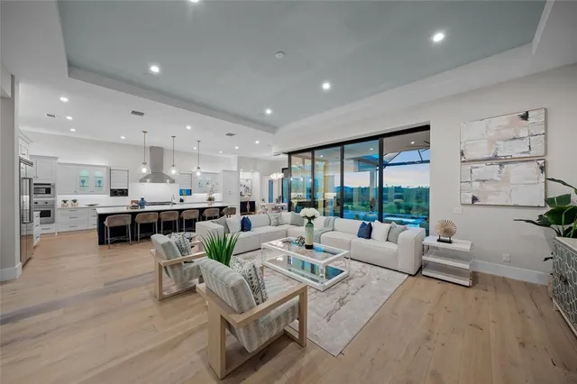 a living room with furniture floor to ceiling window and potted plant