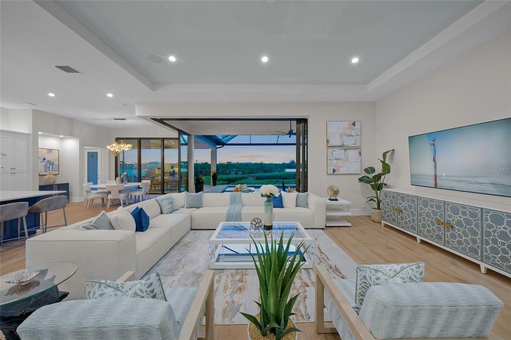 1109 Bayshore Road Nokomis, FL 34275 - Photo 8 of 63 a living room with furniture floor to ceiling window and wooden floor