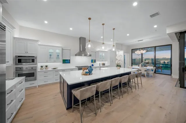 a large kitchen with kitchen island a sink counter space and appliances