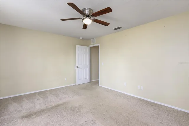 an empty room with a ceiling fan and a ceiling fan