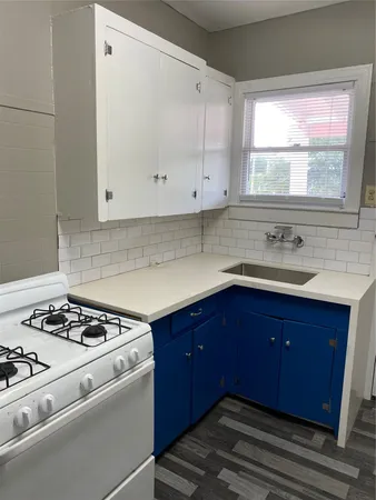 a kitchen with a sink and a stove