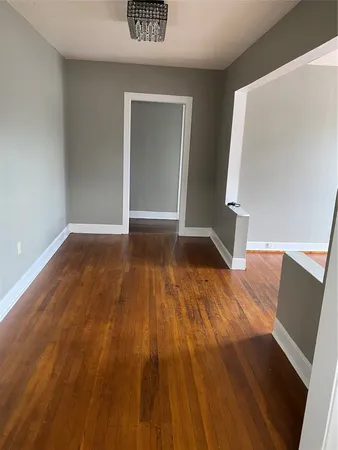 a view of an empty room and wooden floor