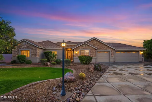 a view of a front of a house with a yard and garage