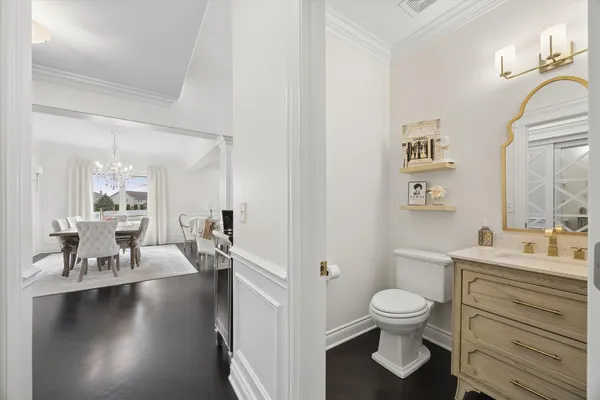 a bathroom with a toilet a sink and a mirror