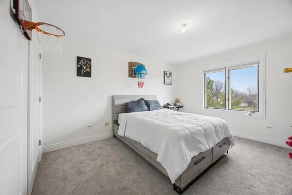 a bed room with a bed and a window