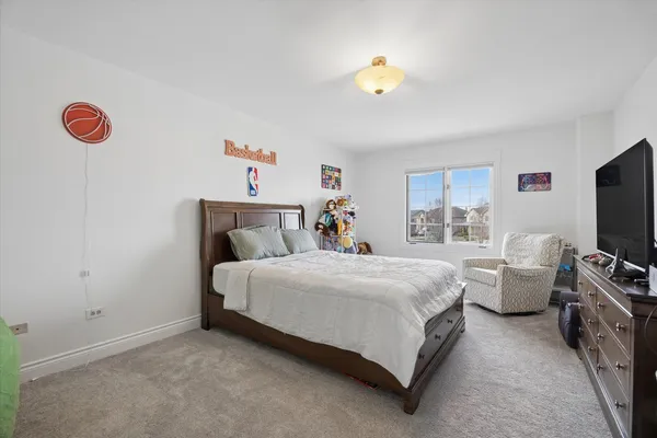 a bedroom with bed and window