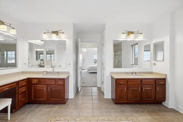 a spacious bathroom with a granite countertop sink and a mirror